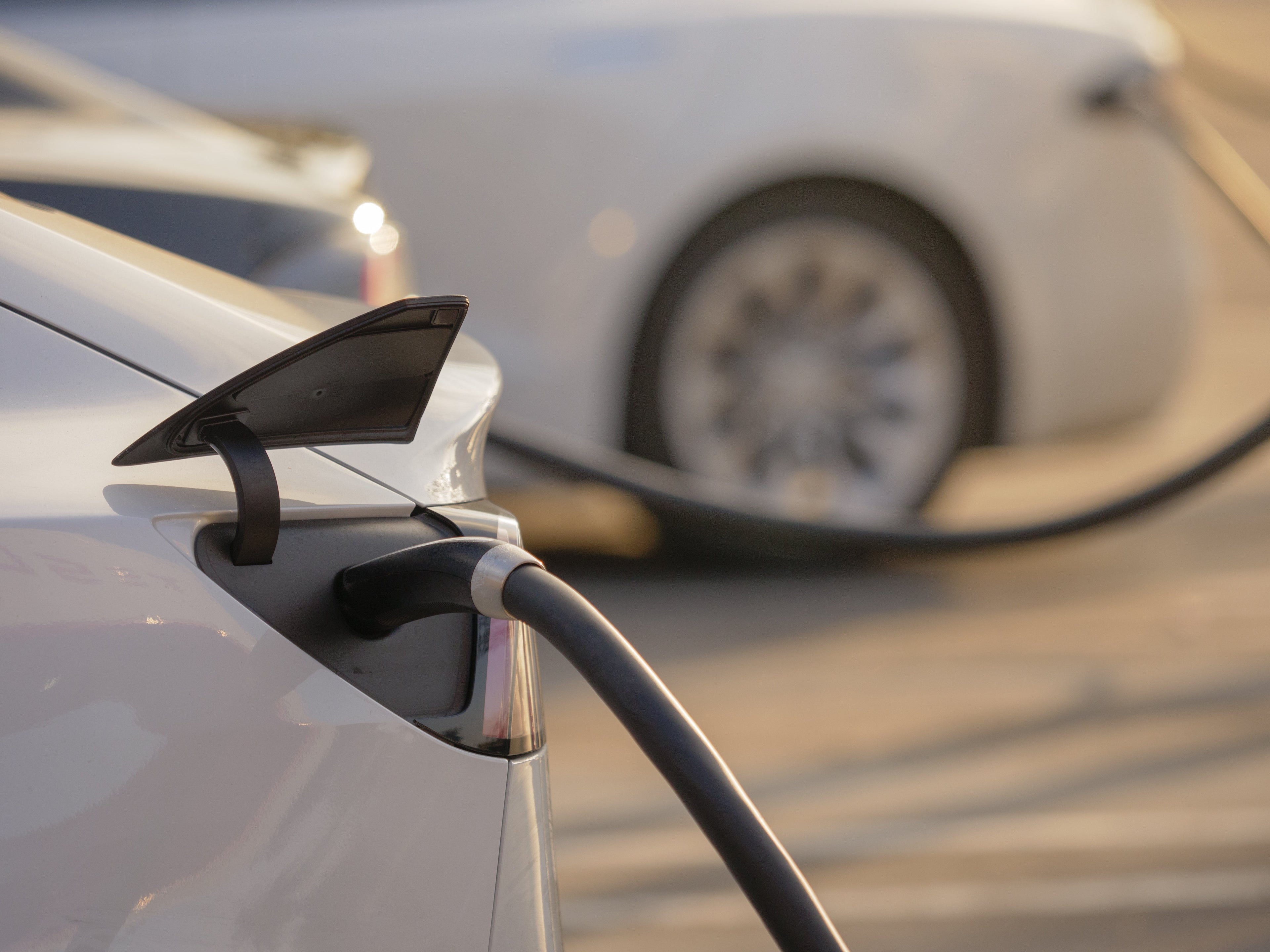 Electric vehicles charging at sunset — best dash cams for EVs in Australia